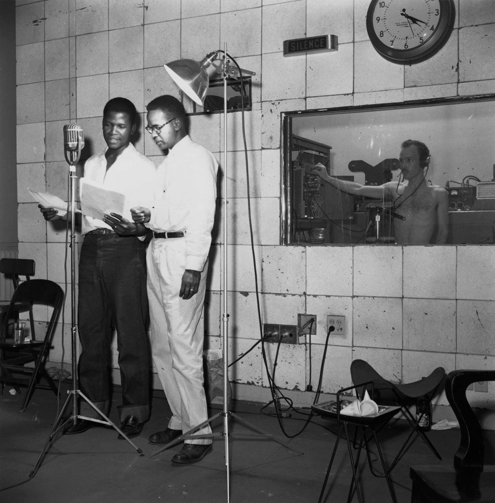 Griffith J. Davis. Griff Davis reviews the script for Liberia’s first promotional film “Pepperbird Land” with its narrator, emerging actor Sidney Poitier in Monrovia, Liberia, 1952. Griffith J. Davis Photographs and Archives.